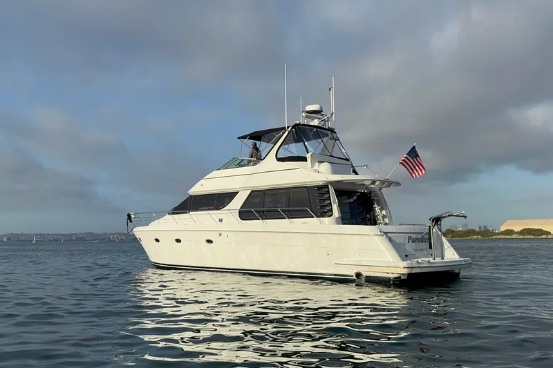 Slide: The Image of 2000 Carver 530 Voyager Pilothouse yacht on calm water, American flag displayed. - 12