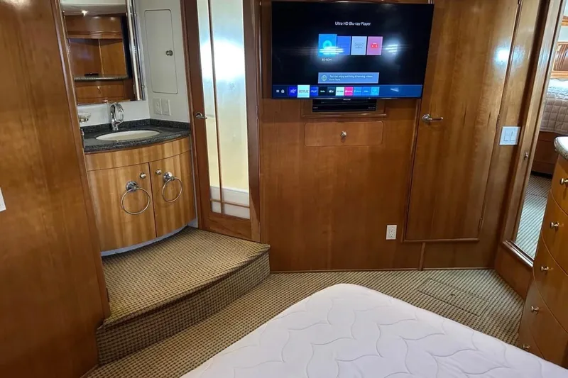 Slide: The Image of Interior of 2000 Carver 530 Voyager Pilothouse with TV, sink, and wooden cabinetry. - 15