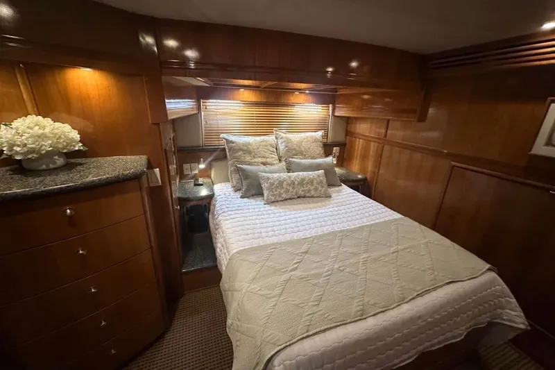 Slide: The Image of Luxurious bedroom interior of 2000 Carver 530 Voyager Pilothouse yacht with elegant wood finish. - 22