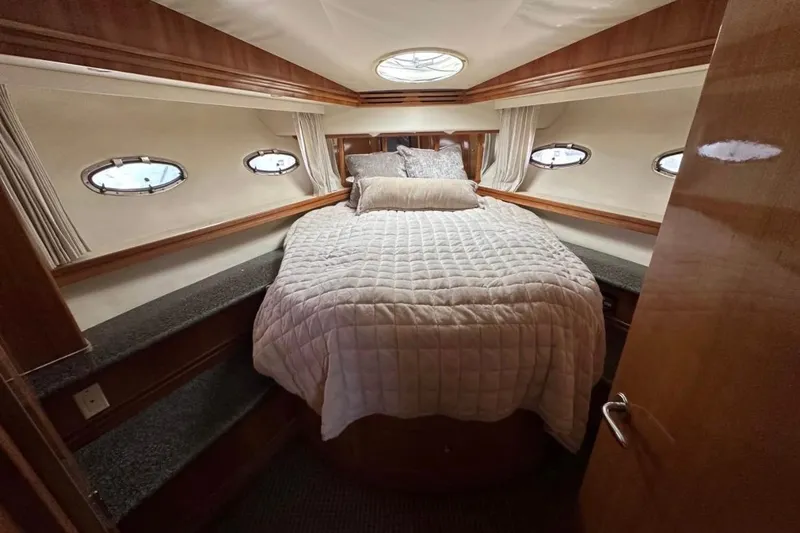 Slide: The Image of Luxurious bedroom interior of 2000 Carver 530 Voyager Pilothouse yacht with cozy bedding. - 24