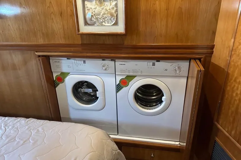 Slide: The Image of Laundry appliances in 2000 Carver 530 Voyager Pilothouse interior, wood paneling background. - 25