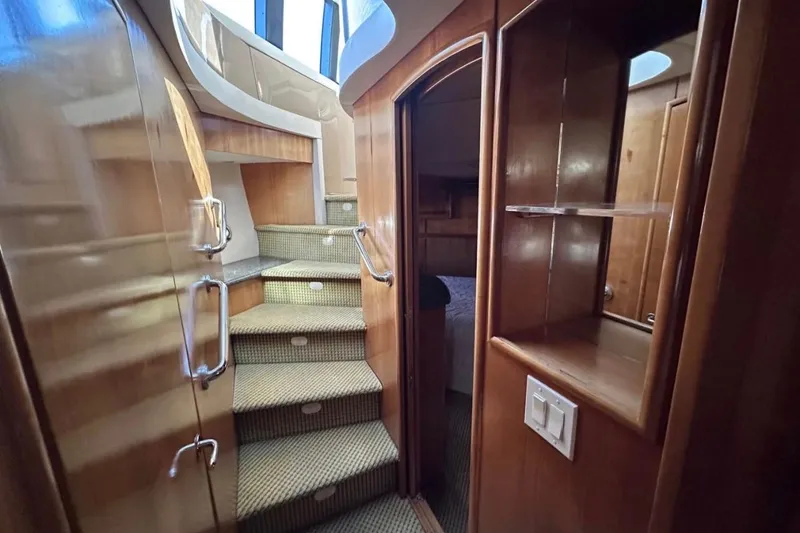 Slide: The Image of Interior view of 2000 Carver 530 Voyager Pilothouse with carpeted stairs and wooden cabinetry. - 27