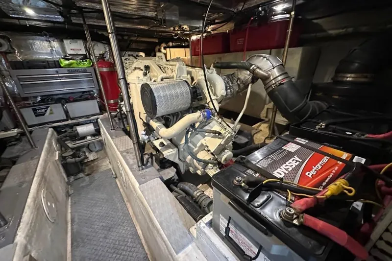 Slide: The Image of Engine room of a 2000 Carver 530 Voyager Pilothouse with visible machinery and batteries. - 28