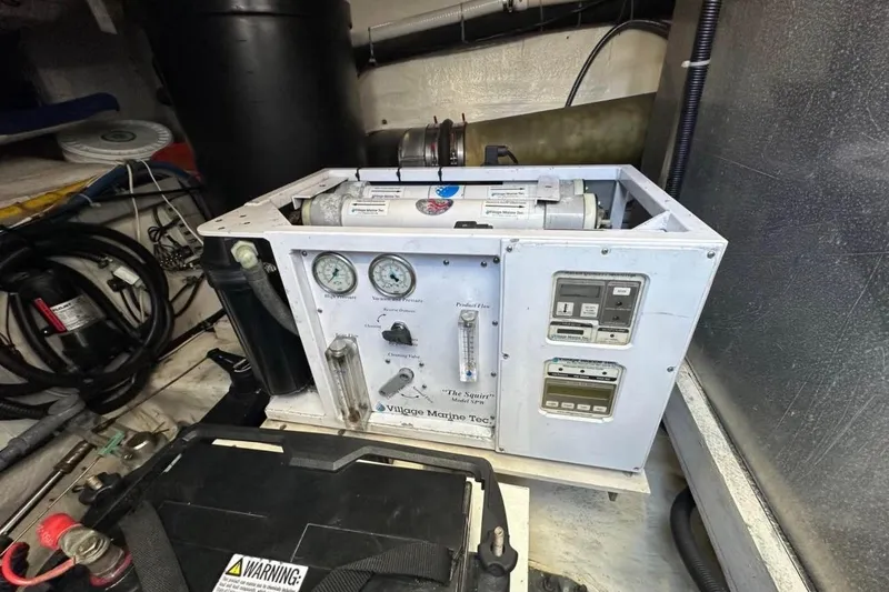 Slide: The Image of Marine equipment in a 2000 Carver 530 Voyager Pilothouse engine room, featuring gauges and controls. - 30