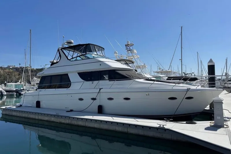 Slide: The Image of 2000 Carver 530 Voyager Pilothouse yacht docked in marina under clear blue sky. - 4