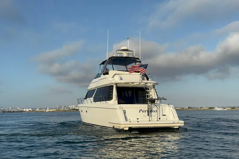 Slide: The Image of Carver 530 Voyager Pilothouse yacht cruising on open water, 2000 model, with American flag. - 8