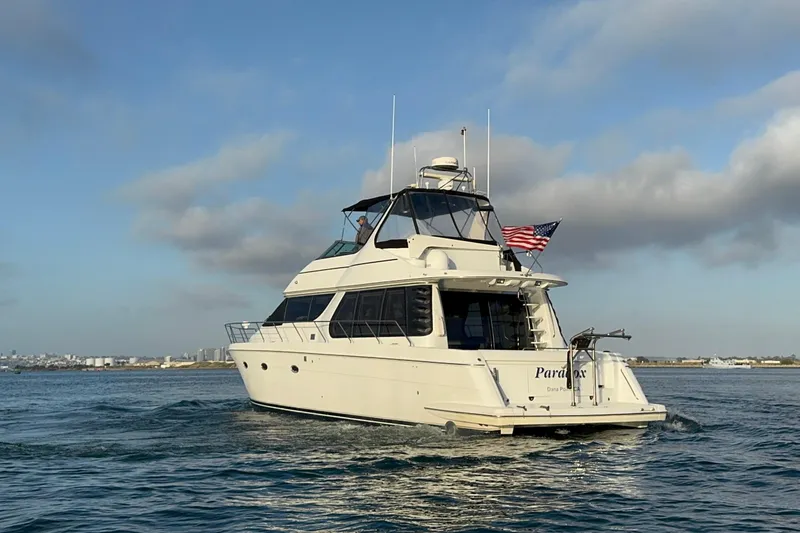 Slide: The Image of 2000 Carver 530 Voyager Pilothouse yacht cruising on open water under a clear sky. - 9