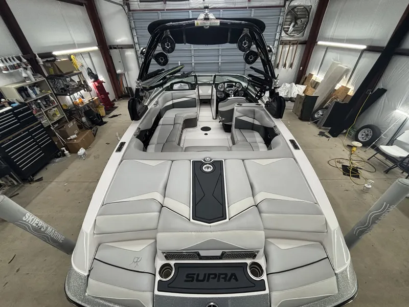 Slide: The Image of Interior view of a 2013 Supra Launch SA350 boat in a workshop. - 10