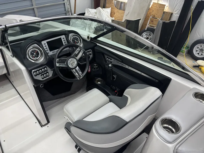 Slide: The Image of Interior of a 2013 Supra Launch SA350 boat with steering console. - 12