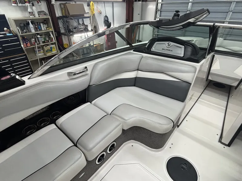 Slide: The Image of Interior of a 2013 Supra Launch SA350 boat, gray upholstery. - 13