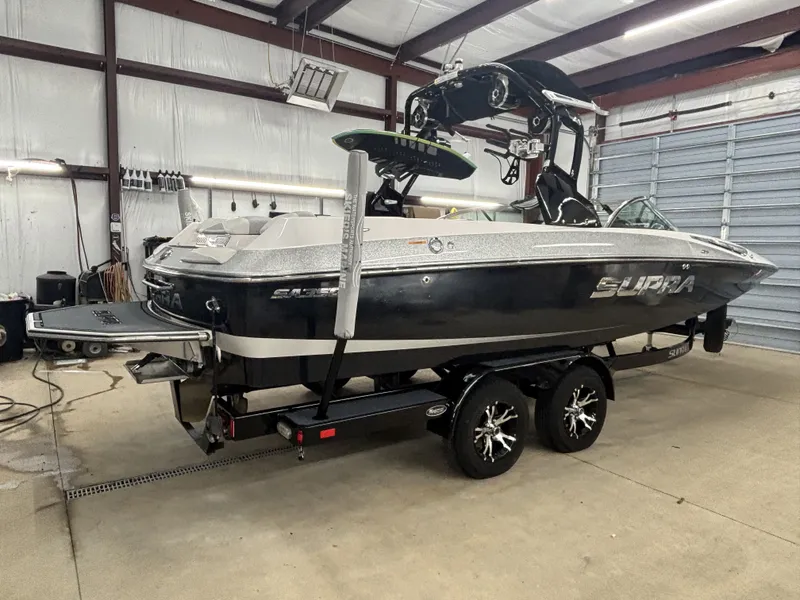 Slide: The Image of 2013 Supra Launch SA350 boat in warehouse on trailer. - 2