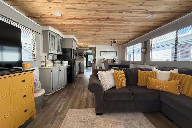 Slide: The Image of Cozy living space in a 1988 STARDUST 16x70 houseboat with modern decor and wooden ceiling. - 12