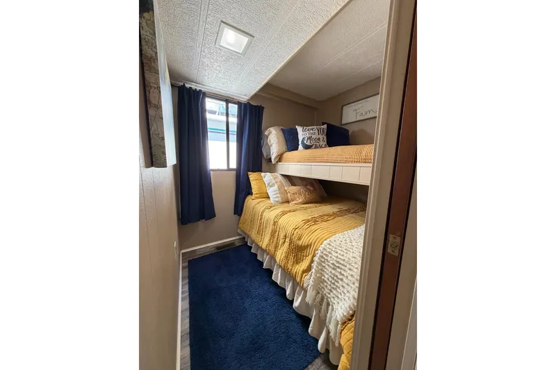 Slide: The Image of Cozy bunk bed room with yellow bedding in 1988 STARDUST 16x70 model. - 20
