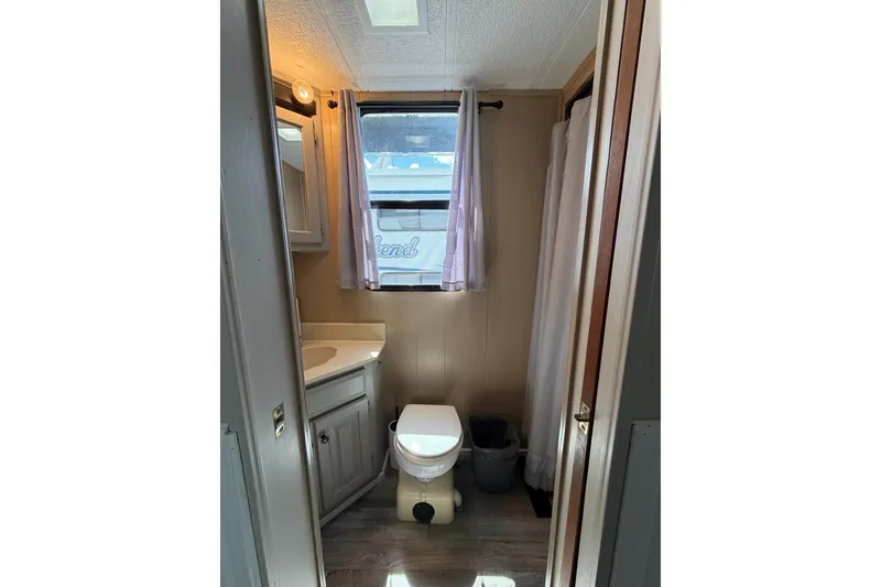Slide: The Image of Bathroom interior of 1988 STARDUST 16x70 houseboat with window and shower. - 21