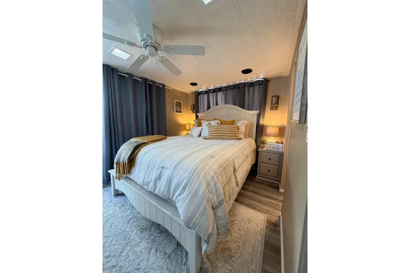 Slide: The Image of Cozy bedroom in 1988 STARDUST 16x70 houseboat with elegant decor and soft lighting. - 26