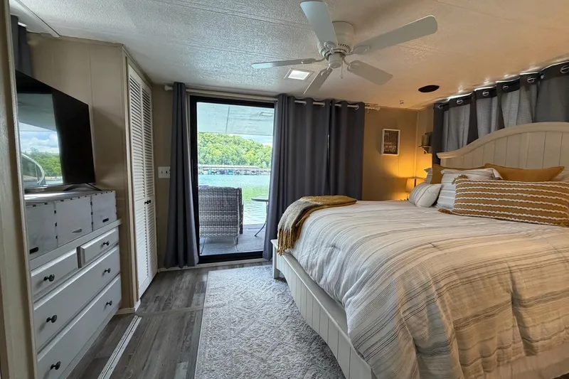 Slide: The Image of Cozy bedroom in 1988 STARDUST 16x70 houseboat with lake view and modern decor. - 29