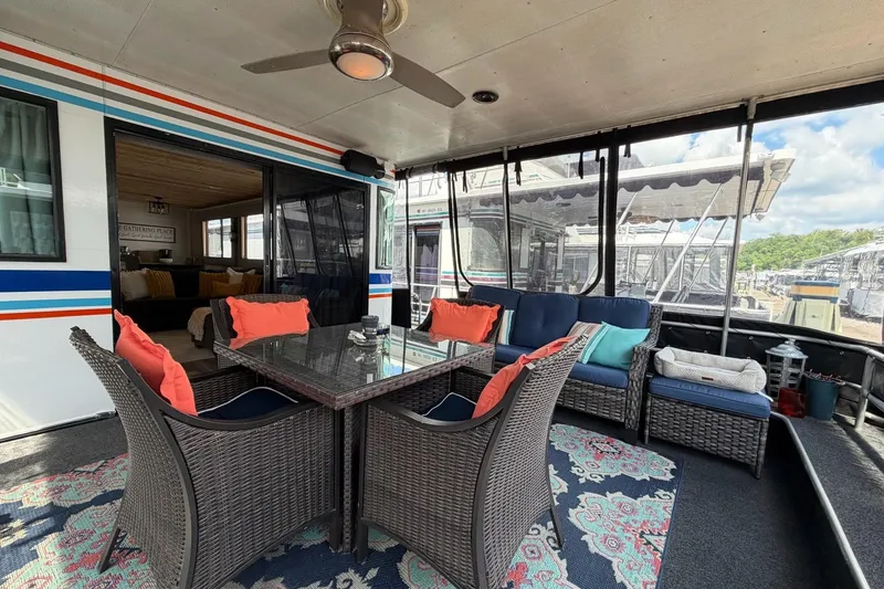Slide: The Image of Outdoor seating area on 1988 STARDUST 16x70 houseboat with wicker furniture and colorful cushions. - 3