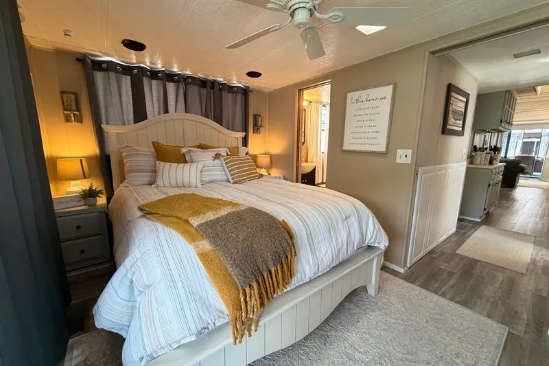 Slide: The Image of Cozy bedroom in 1988 STARDUST 16x70 houseboat with modern decor and warm lighting. - 30