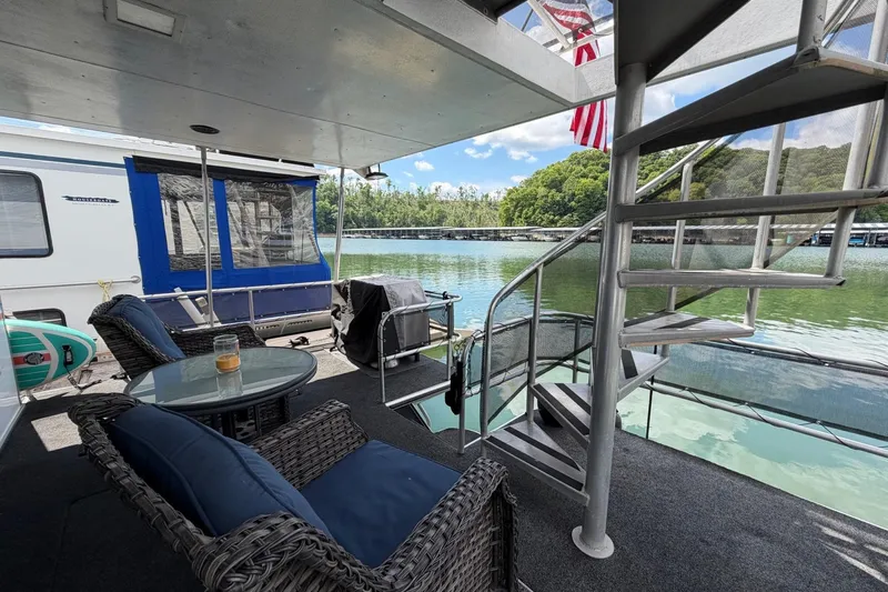 Slide: The Image of Houseboat deck with wicker furniture, spiral staircase, and lake view, STARDUST 16x70, 1988 model. - 37
