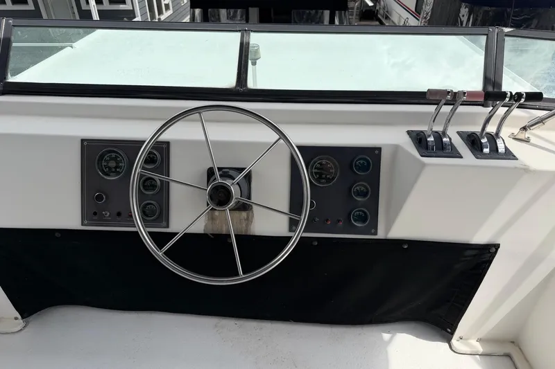 Slide: The Image of Control panel of a 1988 STARDUST 16x70 boat with steering wheel and gauges. - 45