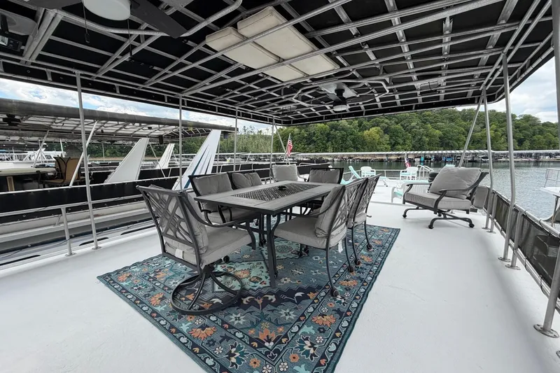Slide: The Image of Upper deck of 1988 STARDUST 16x70 houseboat with outdoor seating and scenic marina view. - 57