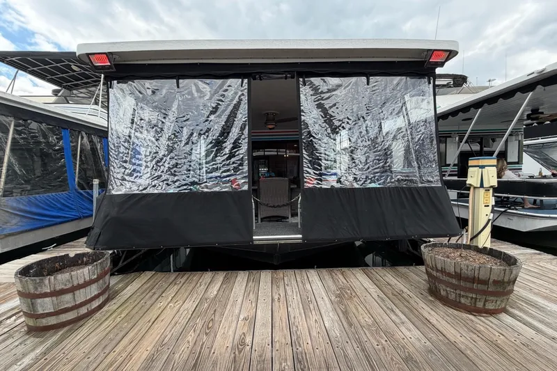 Slide: The Image of Houseboat docked with clear vinyl enclosure, STARDUST 16x70, 1988 model. - 58