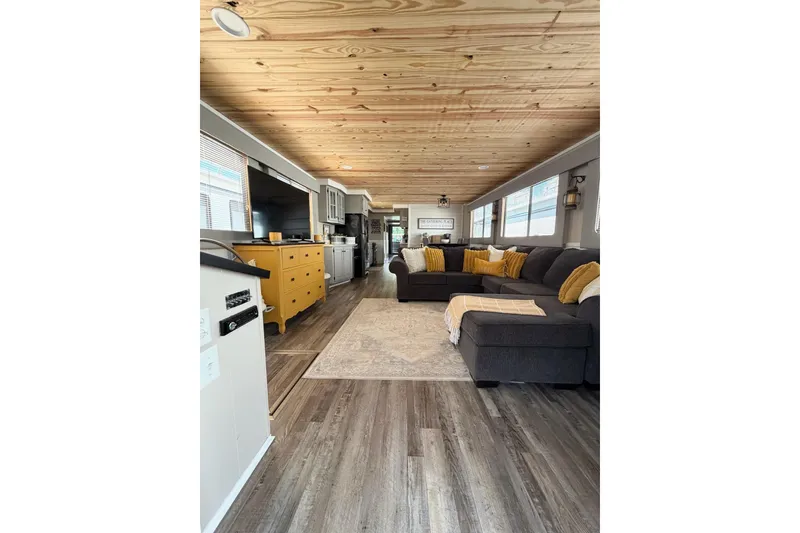 Slide: The Image of Spacious interior of 1988 STARDUST 16x70 houseboat with modern decor and wooden ceiling. - 6