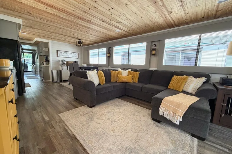 Slide: The Image of Spacious 1988 STARDUST 16x70 houseboat interior with cozy seating and rustic decor. - 8