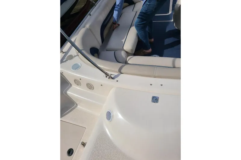 Slide: The Image of 2006 Hurricane FunDeck GS 232 IO interior with beige seating and person standing. - 10