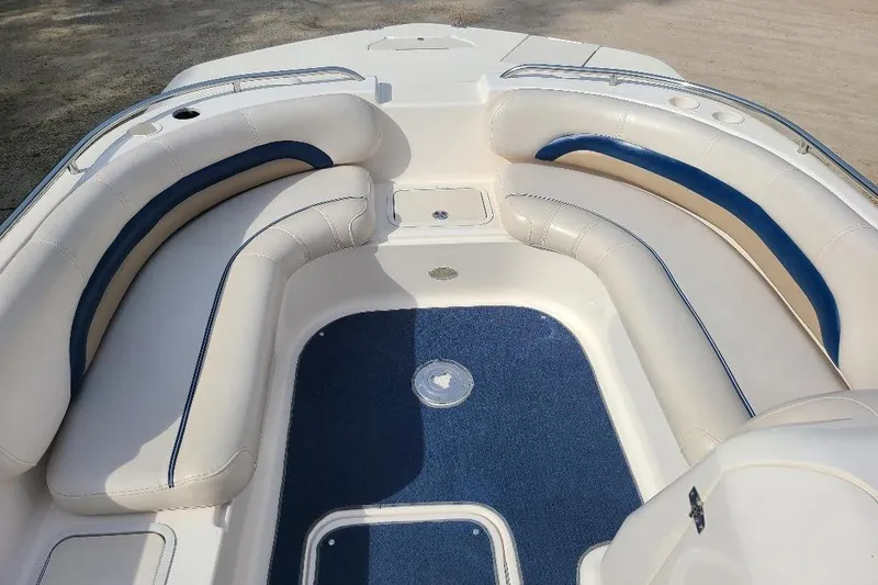 Slide: The Image of 2006 Hurricane FunDeck GS 232 IO boat interior with white and blue seating. - 4