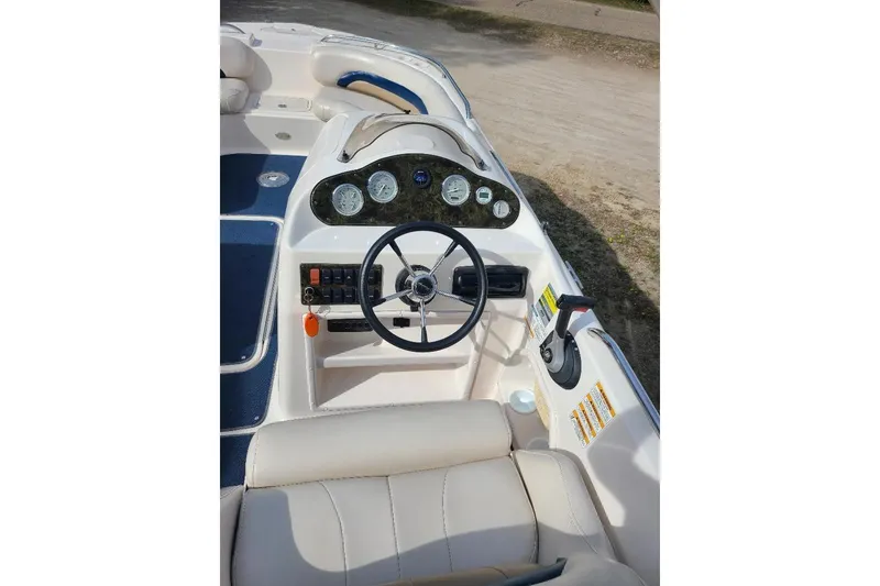 Slide: The Image of 2006 Hurricane FunDeck GS 232 IO boat dashboard with steering wheel and controls. - 6