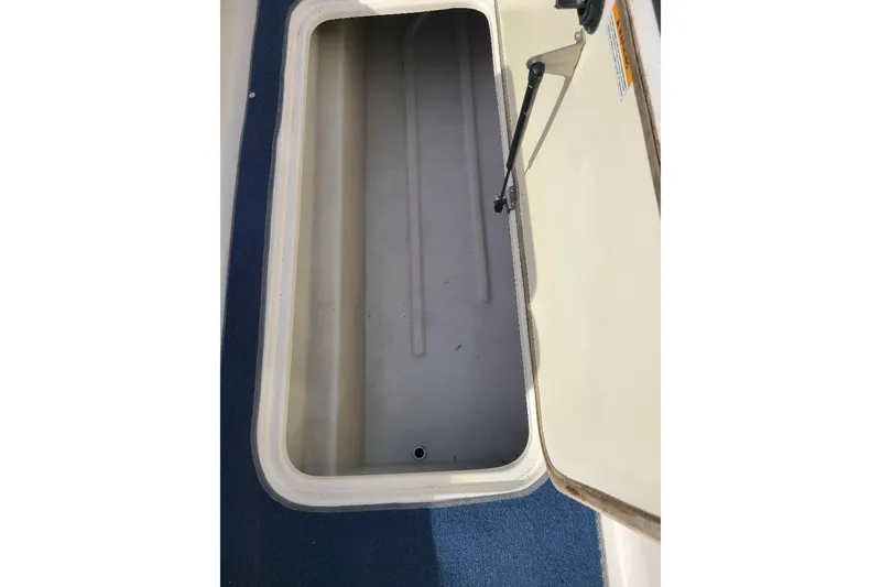 Slide: The Image of Open storage compartment on 2006 Hurricane FunDeck GS 232 IO boat. - 9
