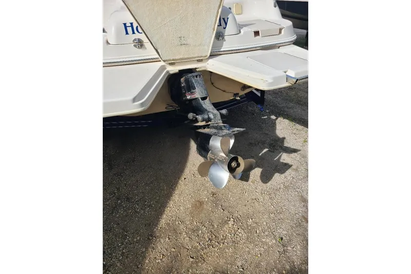 Slide: The Image of 2006 Hurricane FunDeck GS 232 IO boat stern with propeller, parked on gravel. - 11