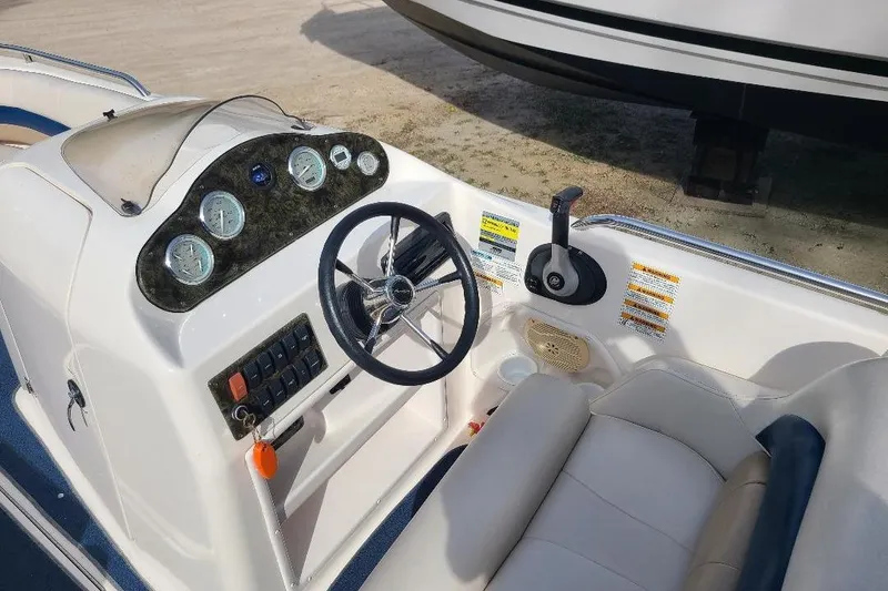 Slide: The Image of 2006 Hurricane FunDeck GS 232 IO boat dashboard with steering wheel and controls. - 3