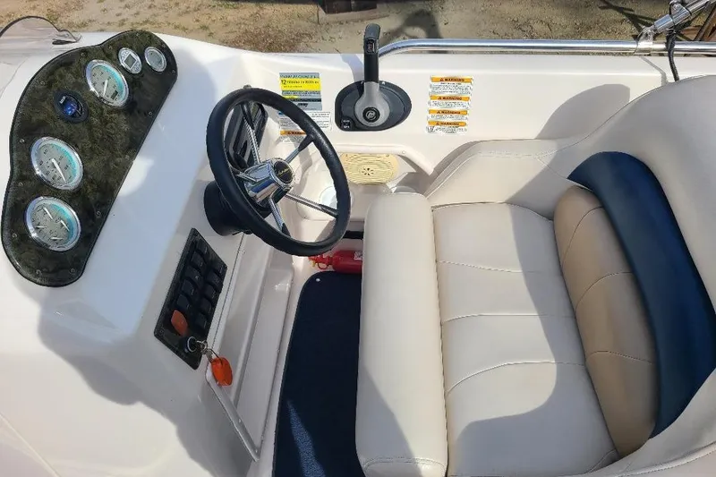 Slide: The Image of 2006 Hurricane FunDeck GS 232 IO boat cockpit with steering wheel and gauges. - 5