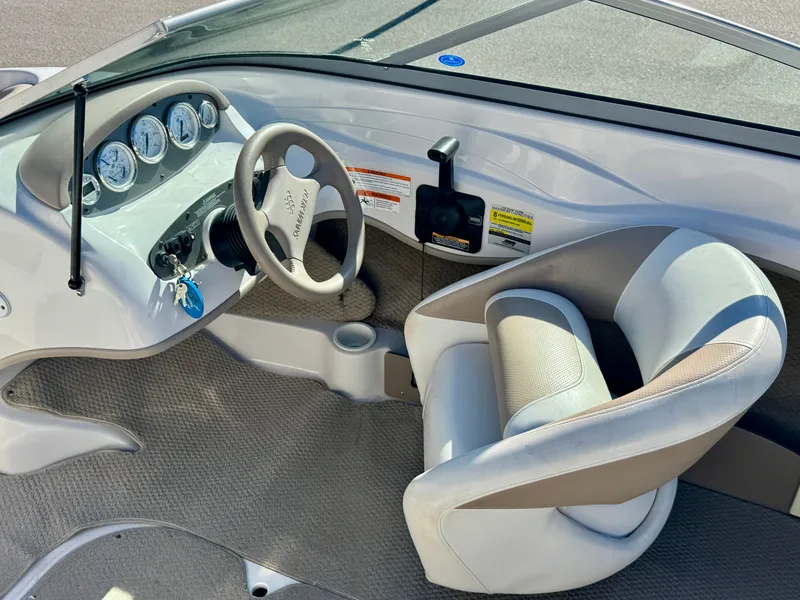 Slide: The Image of Interior of a 2006 Four Winns 190 Horizon boat with steering wheel and seat. - 13