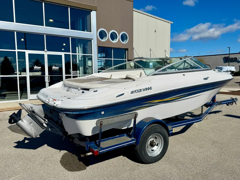 Slide: The Image of 2006 Four Winns 190 Horizon boat on trailer outside building. - 3