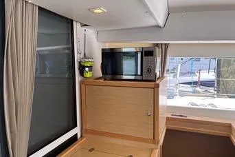 Slide: The Image of Interior of 2018 Lagoon 400 S2 yacht with microwave and window view. - 13