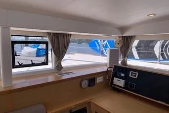 Slide: The Image of Interior view of 2018 Lagoon 400 S2 catamaran with navigation equipment and windows. - 16