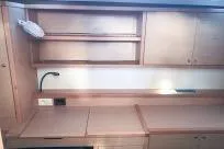 Slide: The Image of Interior of 2018 Lagoon 400 S2 yacht with wooden cabinetry and modern lighting. - 19