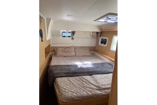 Slide: The Image of Cozy bedroom interior of 2018 Lagoon 400 S2 yacht with double bed and windows. - 20