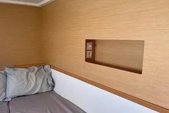 Slide: The Image of 2018 Lagoon 400 S2 cabin interior with wooden paneling and bed. - 21