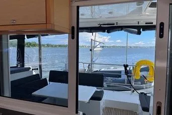 Slide: The Image of 2018 Lagoon 400 S2 catamaran interior with ocean view and seating area. - 24