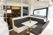 Slide: The Image of 2018 Lagoon 400 S2 yacht interior with dining area and champagne bottle. - 26