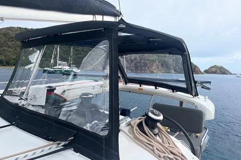 Slide: The Image of 2018 Lagoon 400 S2 catamaran anchored near scenic coastline. - 29