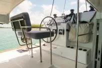 Slide: The Image of Helm station of 2018 Lagoon 400 S2 catamaran with steering wheel and seating. - 32