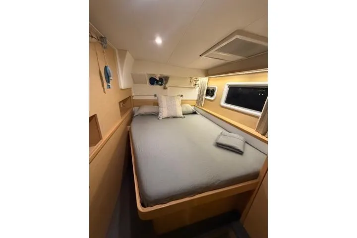 Slide: The Image of Luxurious cabin interior of 2018 Lagoon 400 S2 yacht with cozy bedding and ambient lighting. - 34