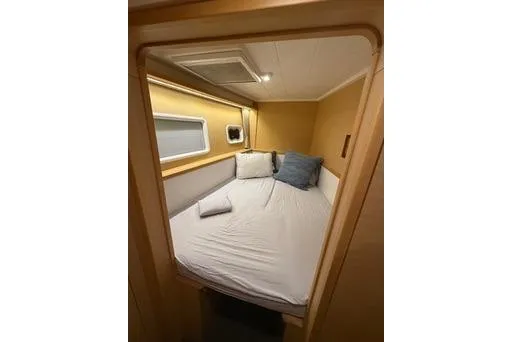 Slide: The Image of Cozy cabin interior of 2018 Lagoon 400 S2 catamaran with bed and pillows. - 35