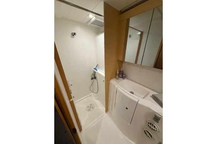 Slide: The Image of 2018 Lagoon 400 S2 yacht bathroom with shower, sink, and mirror. - 36