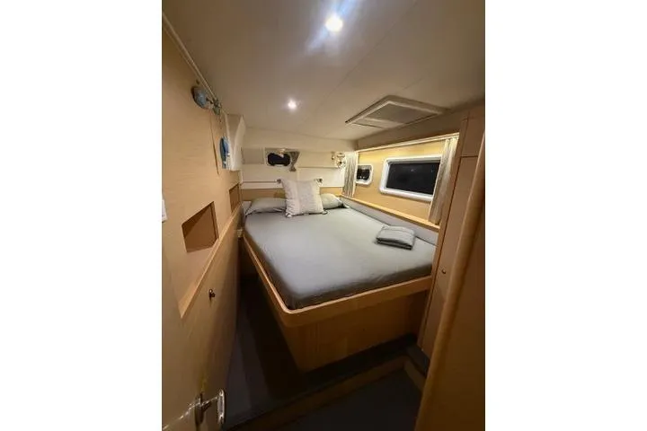 Slide: The Image of Cozy cabin interior of 2018 Lagoon 400 S2 catamaran with comfortable bed and ambient lighting. - 38